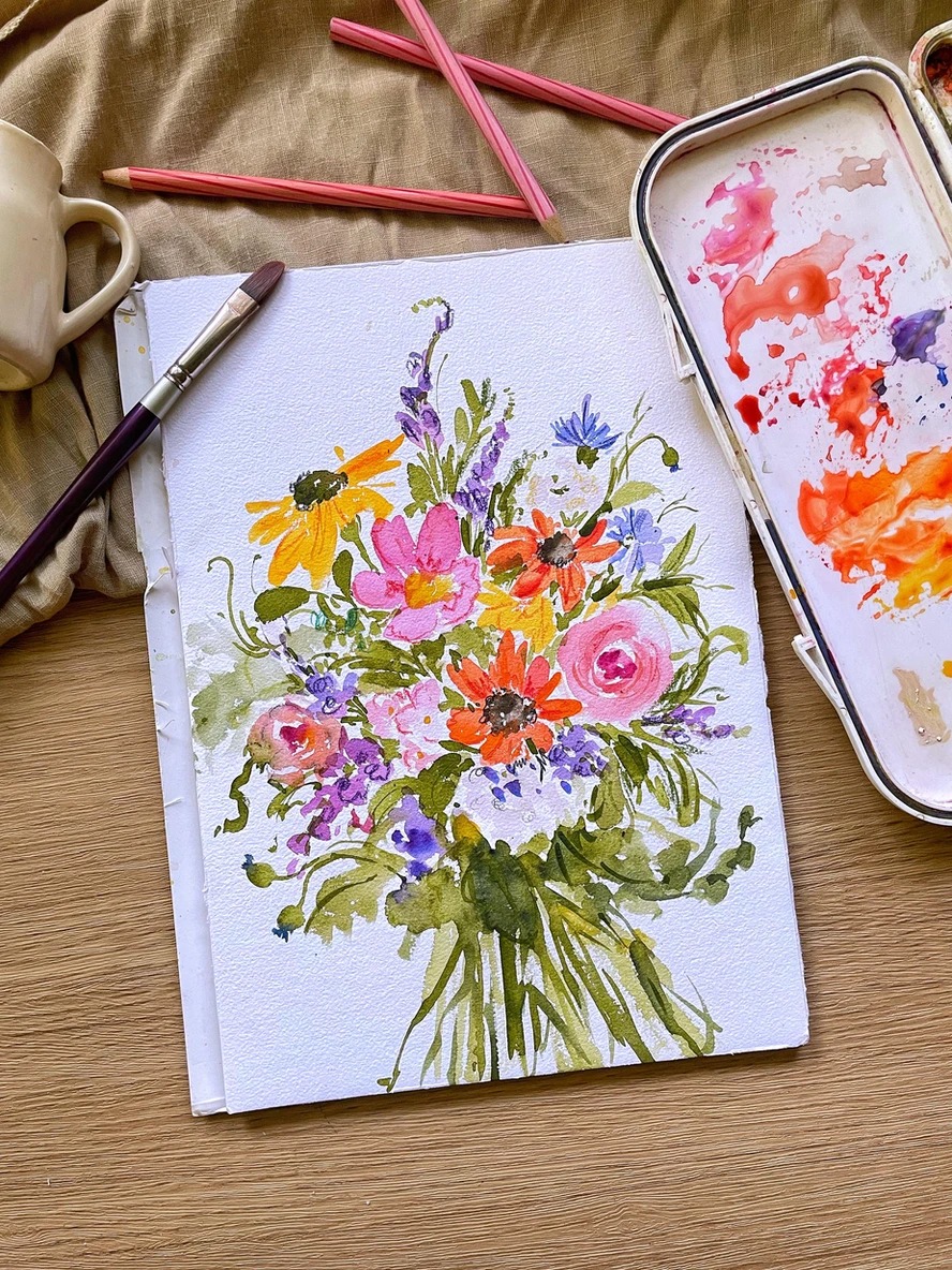 Vivid wildflower bouquet painting with brushes